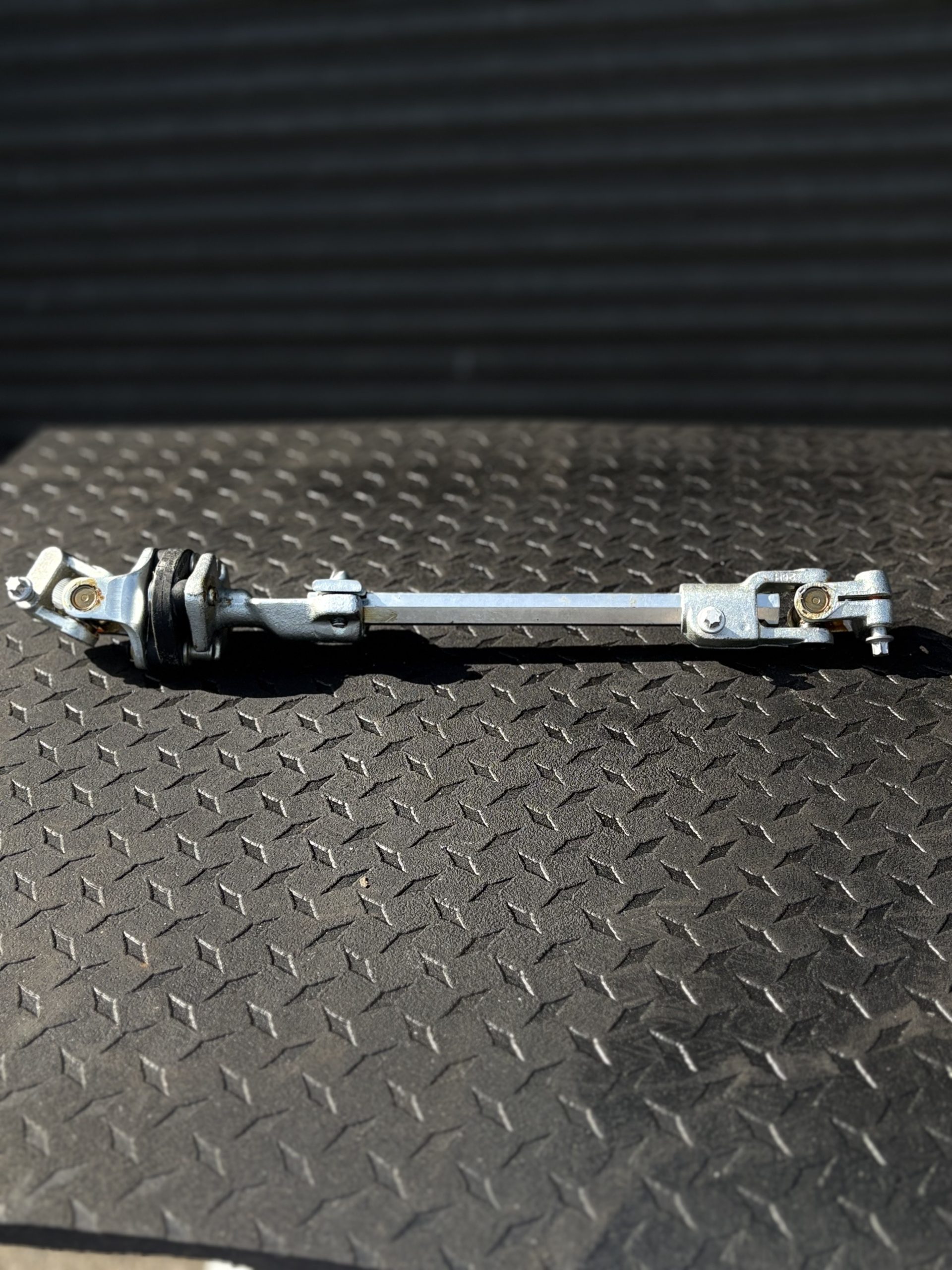 Silver Land Rover Defender, lower steering shaft and UJ assembly
